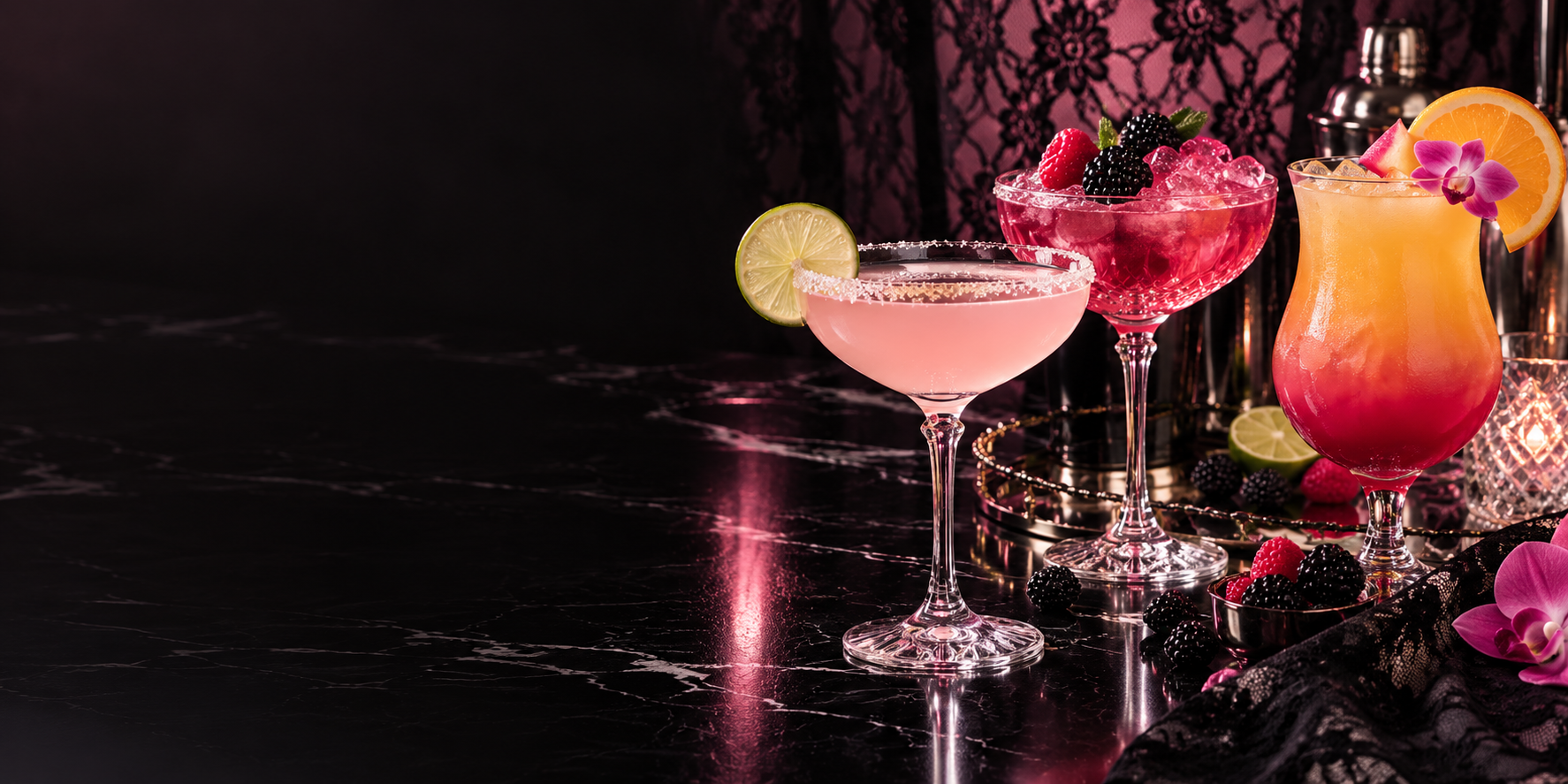 Three glamorous pink cocktails on a glossy black bar